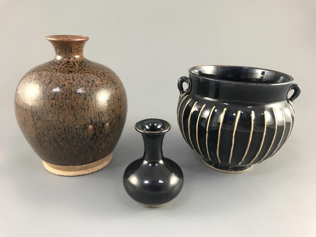 A Chinese blackware ribbed jar, a small blackware vase and a russet and black glazed jar, Yuan dynasty or later